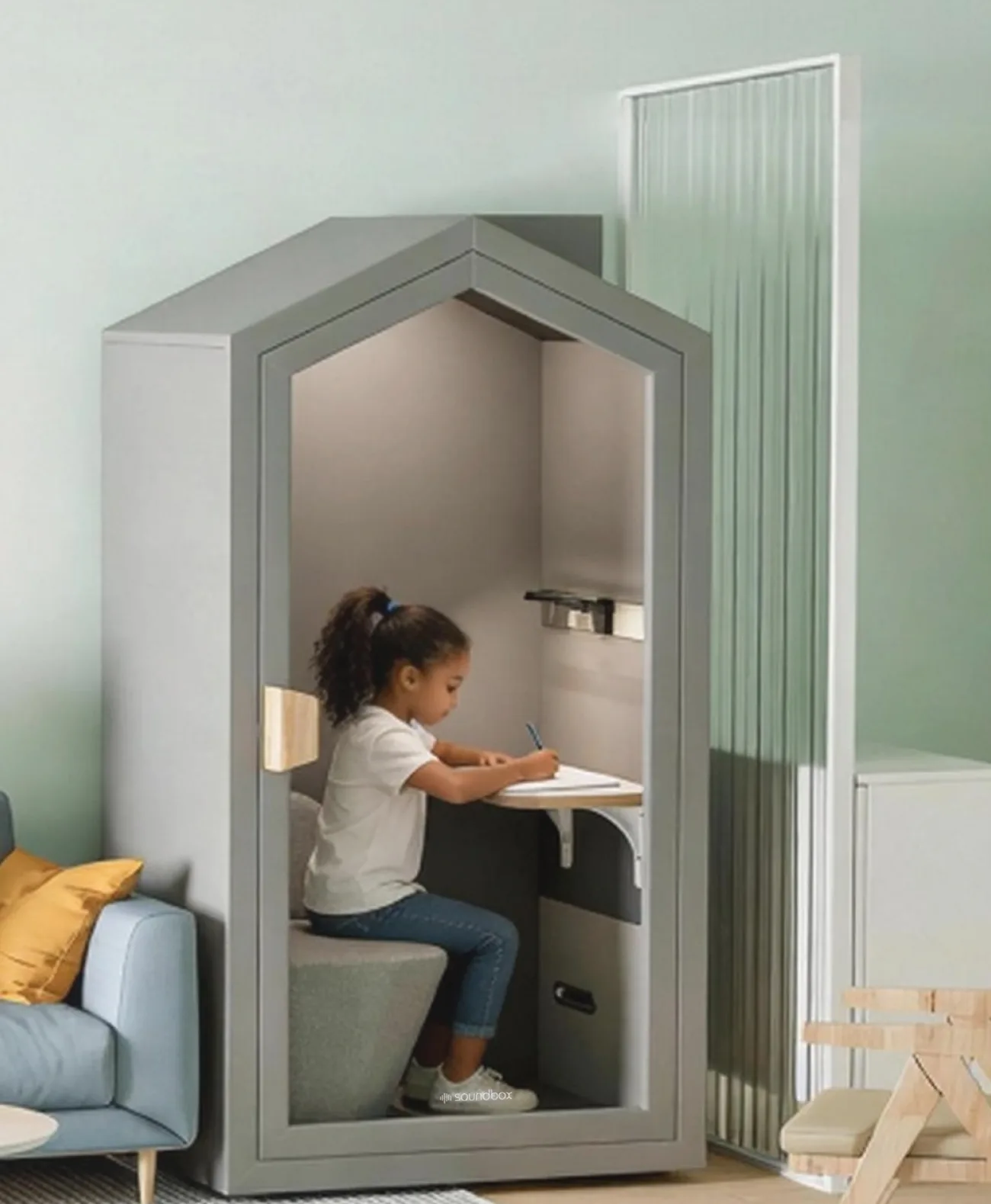 Family relaxing on a sofa while a child studies inside the Home Pod